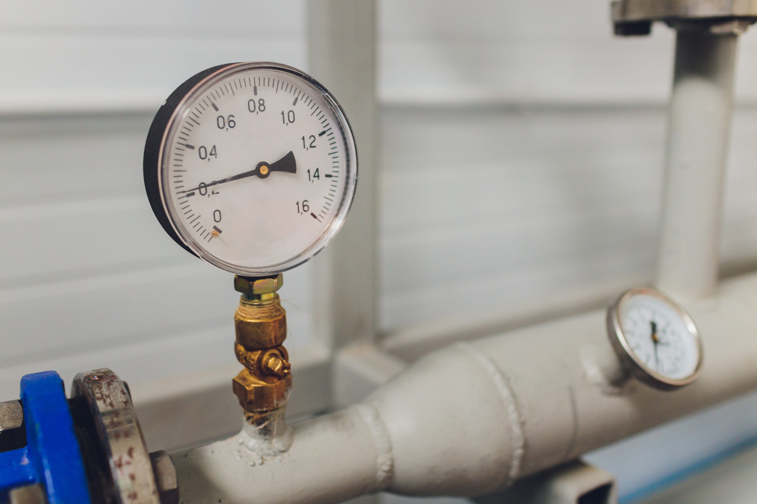 Close up of manometer, pipe, flow meter and faucet valves of heating system in a boiler room