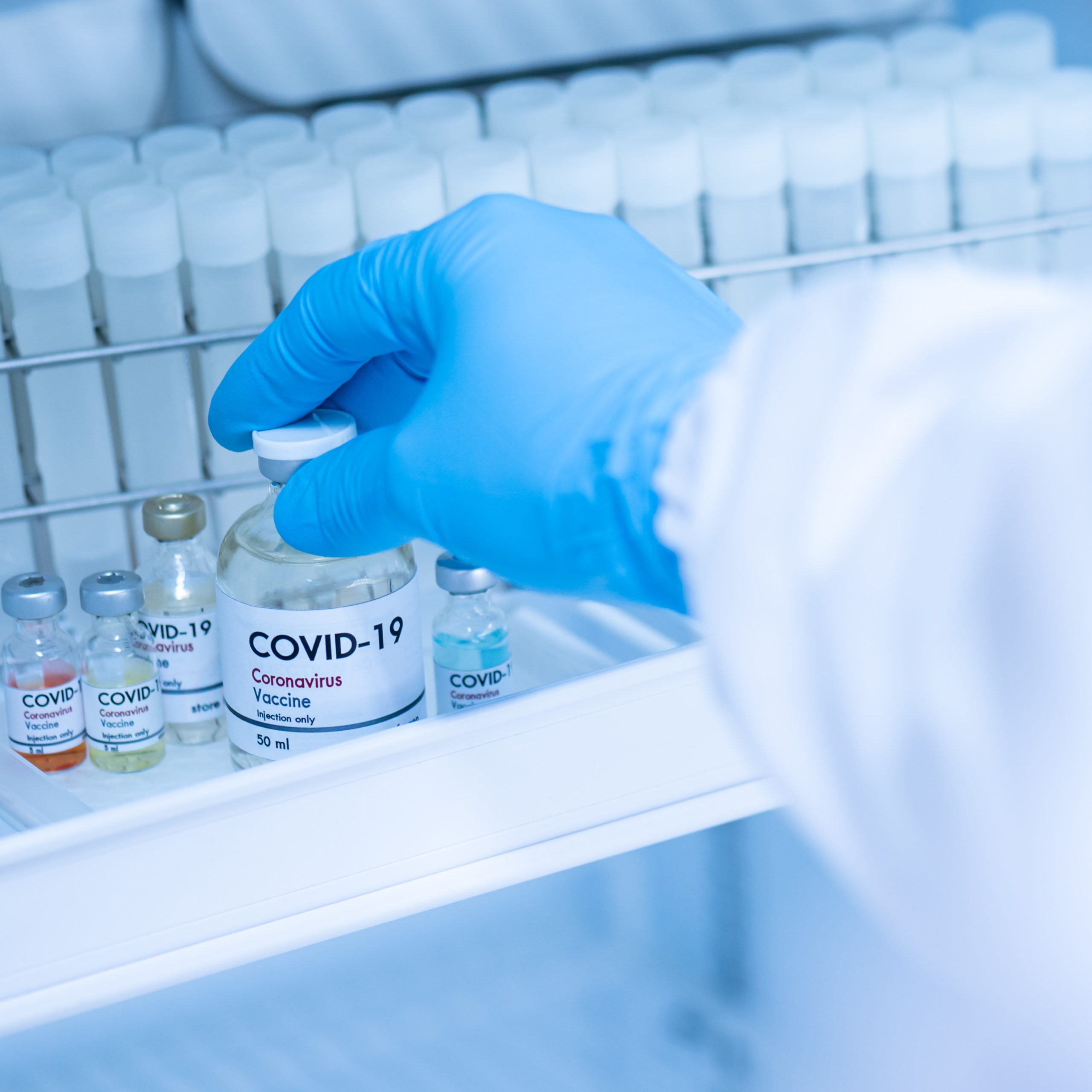 Doctor’s,Hand,Holding,Bottle,Vaccine,To,Patient,In,Storage,Box.vaccination