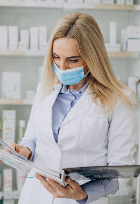 woman-working-at-pharmacy-and-wearing-coat